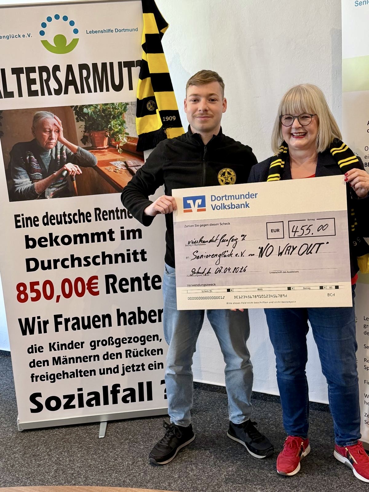 Der erste Vorsitzende des BVB-Fanclubs "NO WAY OUT" überreicht Frau Cornelia Sbosny den Scheck der Dortmunder Volksbank über 455 Euro.